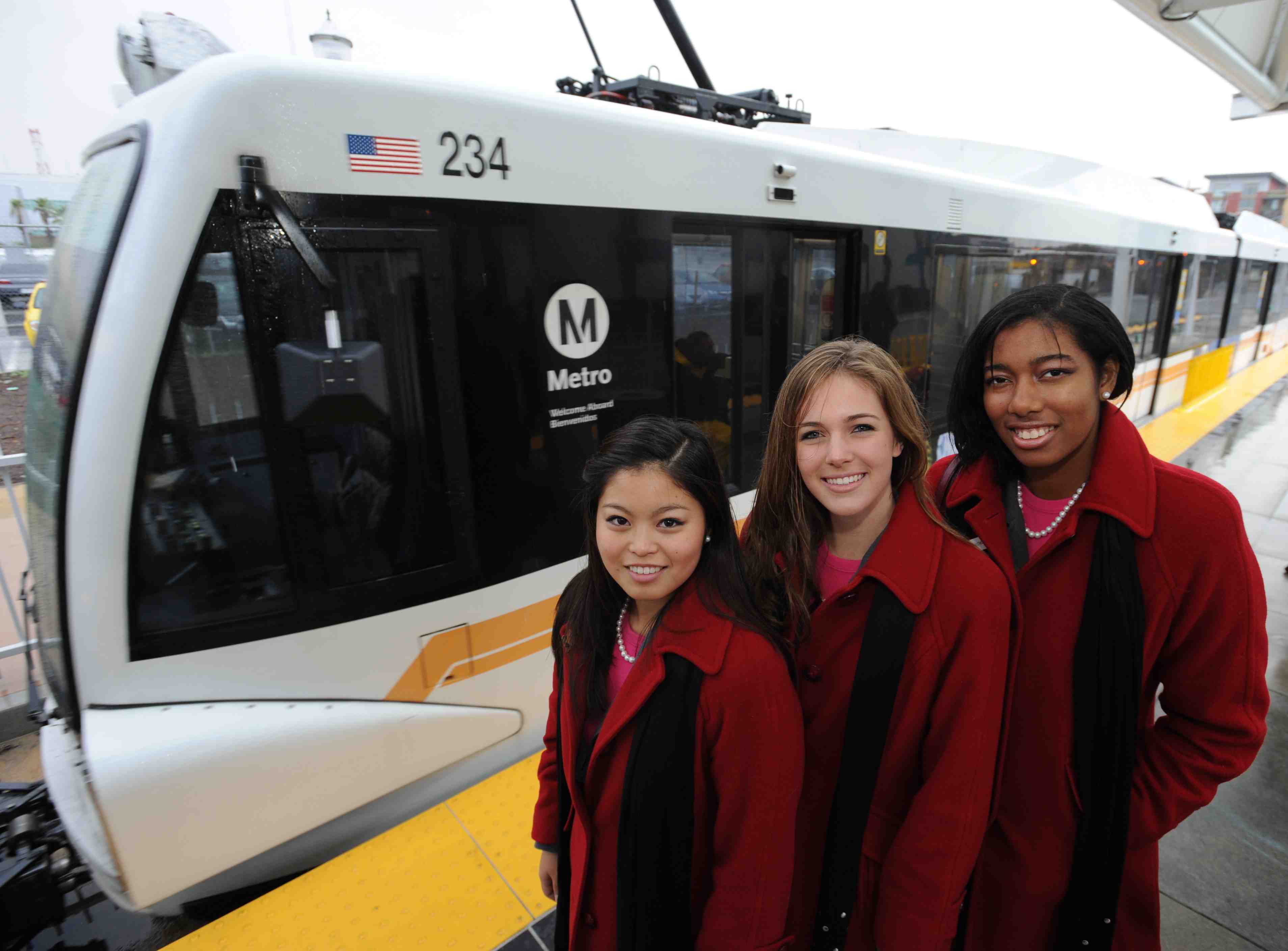 2011 Rose Queen Evanne Elizabeth Friedmann, center, with Princess Tenaya Miyoko Senzaki, left, and Princess Michelle Kaye Washington, join transit officials, civic leaders and members of the L.A. Kimono Club at the Little Tokyo / Arts District Gold Line Station for a ride on the Metro Gold Line to invite parade goers and football fans to Go Metro to the Pasadena New Year’s festivities. Photo by Juan Ocampo.