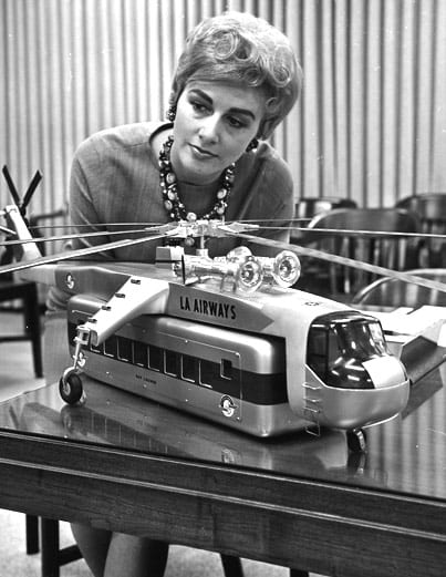 A woman inspects a model of helicopter with passenger-carrying pod in photo published April 4, 1965, in the Los Angeles Times. Photo courtesy of Los Angeles Times photographic archive, UCLA Library.