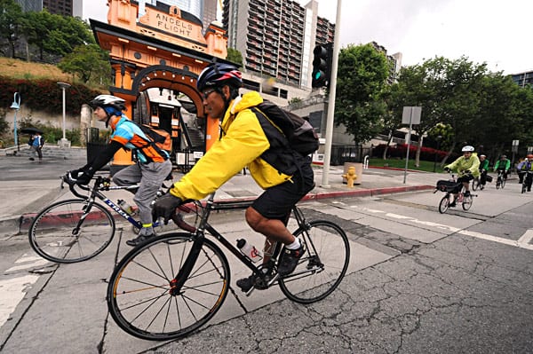 Cyclists ride past Angel's Flight on Hill Street. Cyclists ride past Angel's Flight on Hill Street. Photo by Gary Leonard