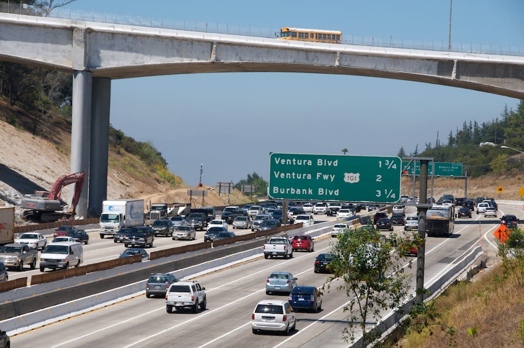 Back Partial demolition of the Mulholland Bridge stopped traffic on Carmageddon weekend. One week later, a school bus crosses on the remaining half of the Mulholland Bridge as traffic pours under the bridge at the start of rush hour on Friday, July 22. Photos by Gary Leonard