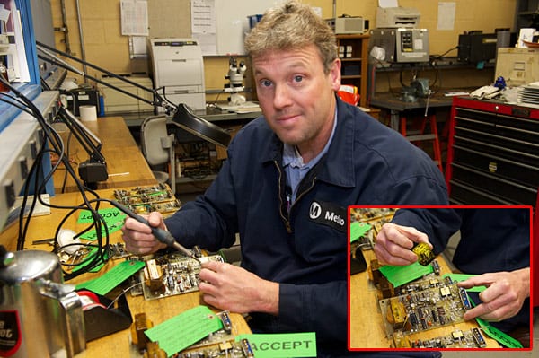 Maintenance specialist Steve Parker modifies a circuit board. Parker and co-worker Gordon Lancaster keep the shop in stock in hard-to-find circuitry replacement parts.