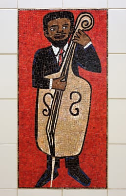 One of 52 individual glass mosaics comprising the artwork by Faith Ringgold titled People Portraits: in Creativity, Performing, Sports and Fashion. Spread across four mezzanine walls at Civic Center Station, images include models walking the catwalk, baseball players, surfers, artists and musicians.