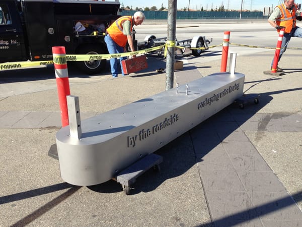 The 12-inch stainless steel base of the sculpture shown just before it is installed. The base contains a quote by Japanese poet Saigo.