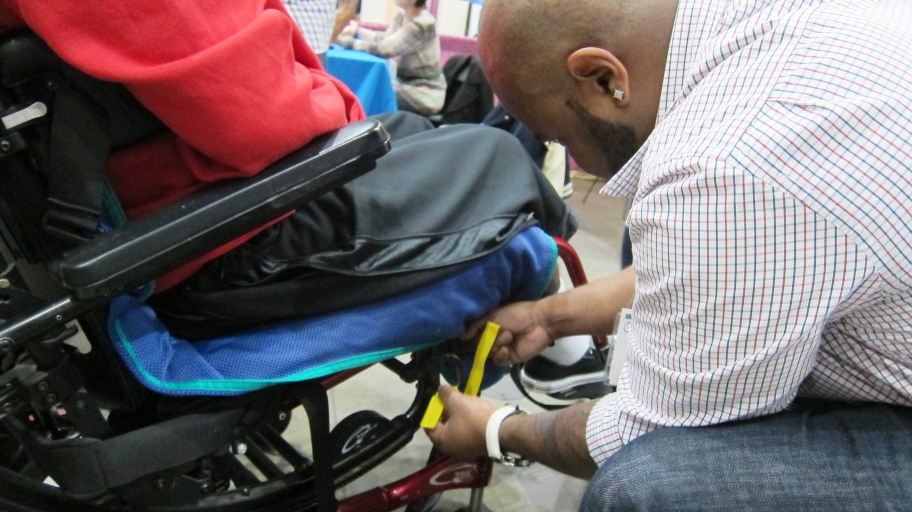 An attendee gets his wheelchair marked for safety straps. Photo by Anna Chen/Metro