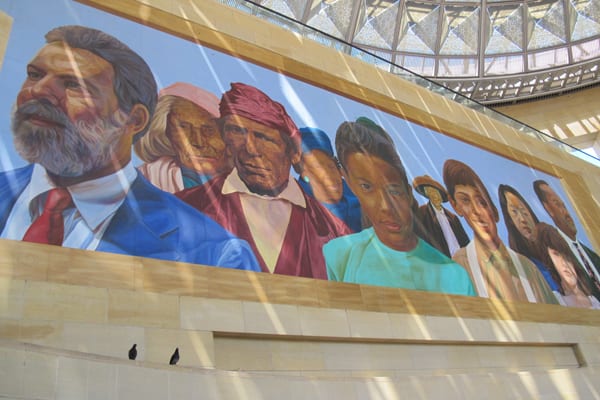 Mural with sun filtering through the glass dome. Pigeon culprits survey the scene.