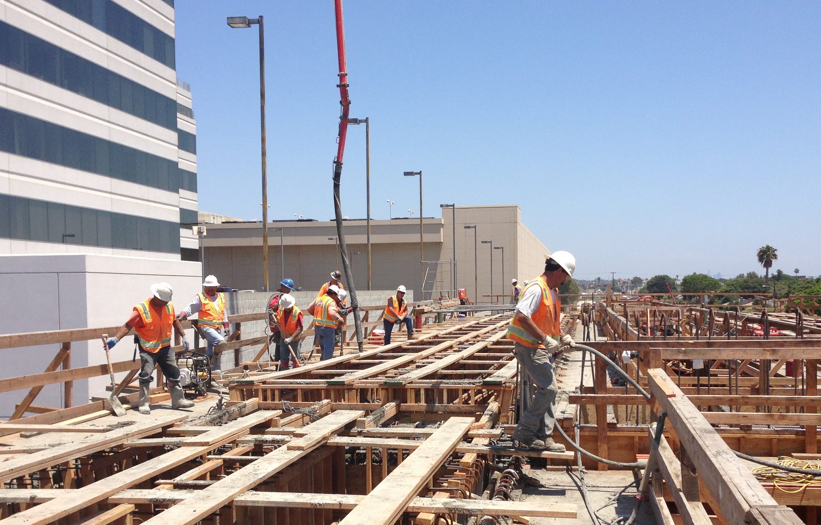 In the photos above and below, work crews use a concrete pump truck with a mounted boom that extends over 100 feet to pump concrete for the bridge pour. Photo: Expo Line Construction Authority.