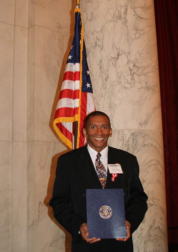 Carlos Medina, Metro Bus operator, holding his award in the United States House of Representatives. Photo: Peru Village LA Facebook.