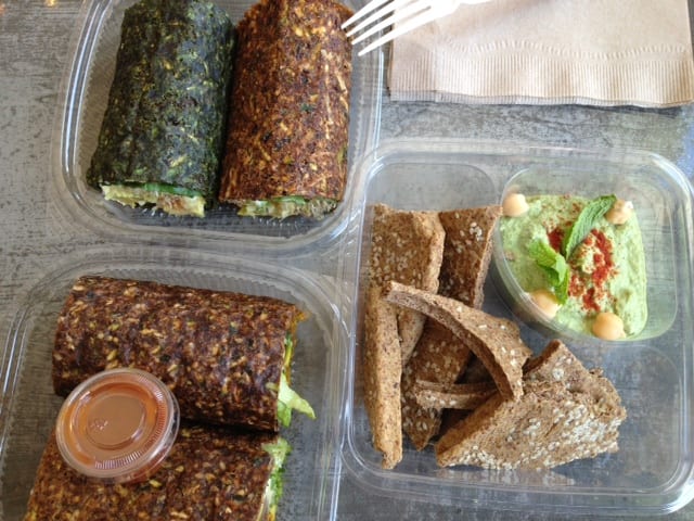 Two kinds of breakfast burritos and sprouted hummus.