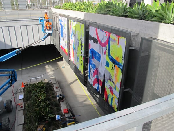 Workers installing Martin Durazo's artwork