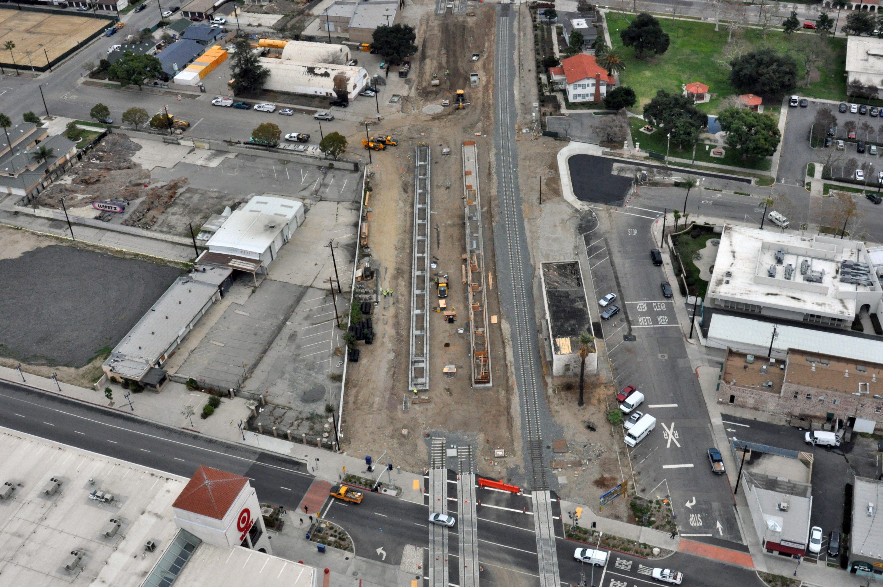 The Gold Line platforms in downtown Azusa next to the old Santa Fe depot along with the newly realigned freight track. 