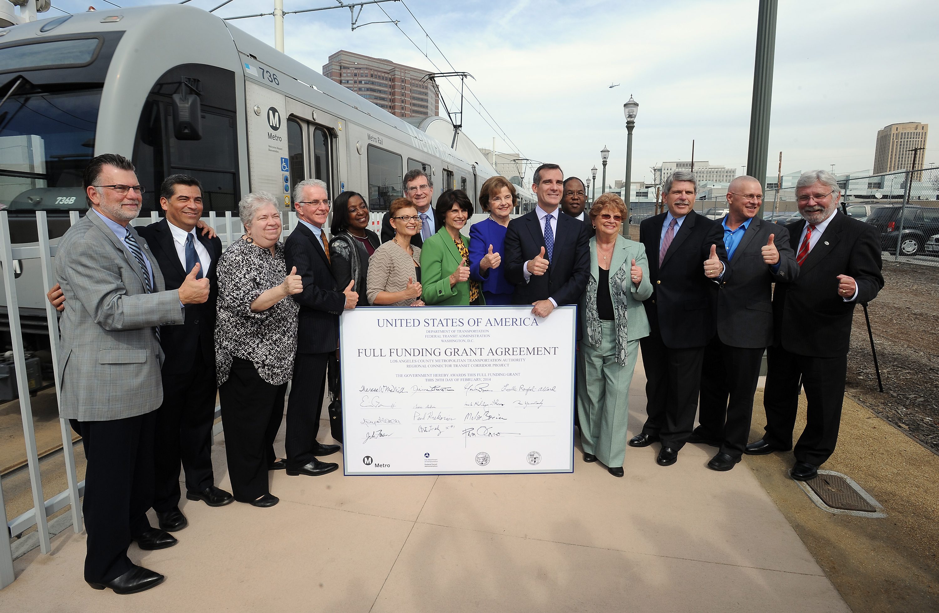 Public officials with a rendering of the Full-Funding Grant Agreement for the Regional Connector. Photo by Juan Ocampo for Metro. 