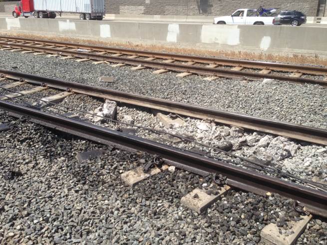 Fallen wire and damaged track near the resting place of the tractor-trailer.