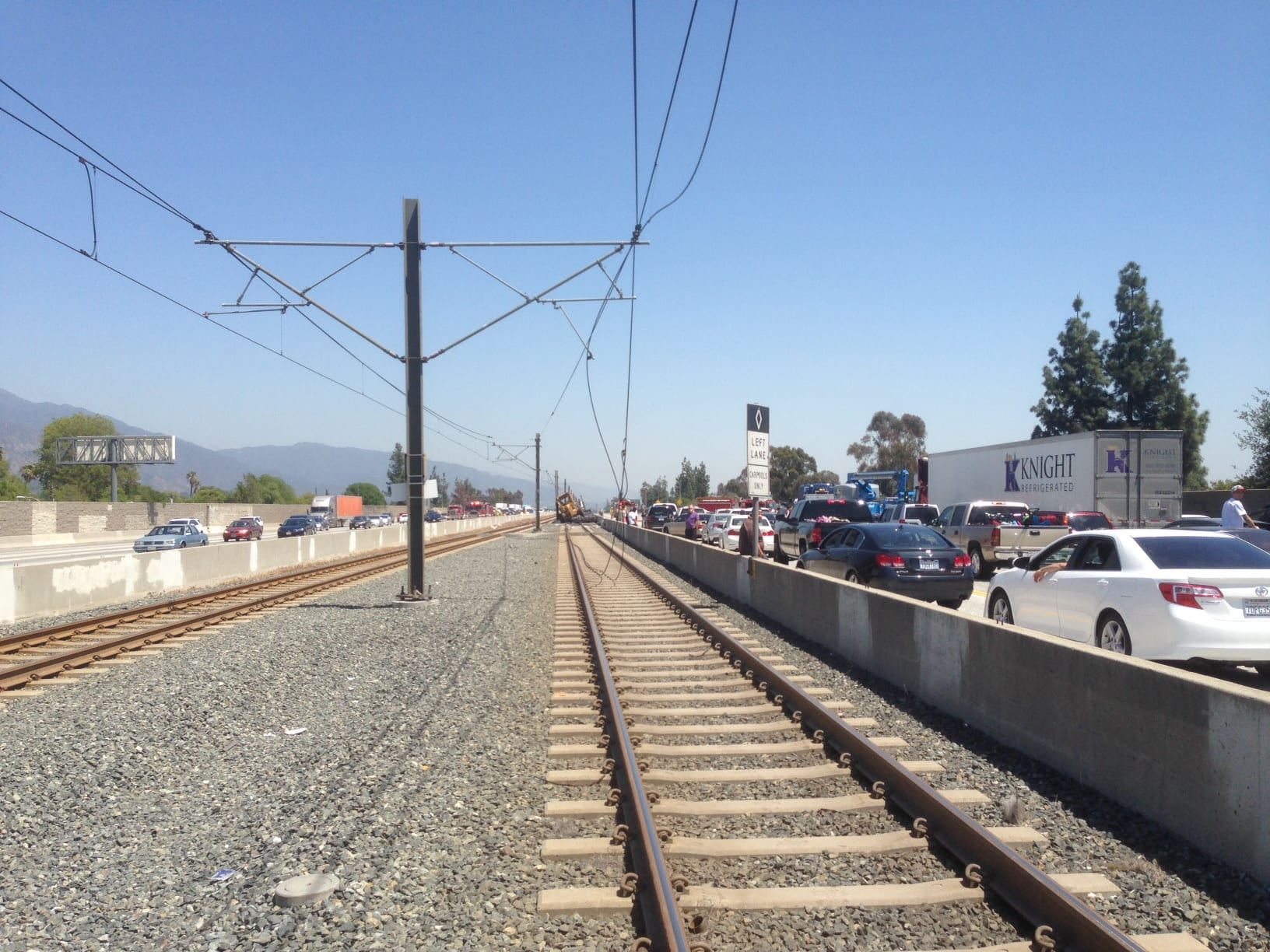 Power supply and support wires droop to the ground after yesterday's big-rig crash. The non-Metro tractor trailer involved in the accident was removed yesterday, but damage to the Gold Line is extensive. (Note the missing cantilevers on the right side of the second and third poles.)