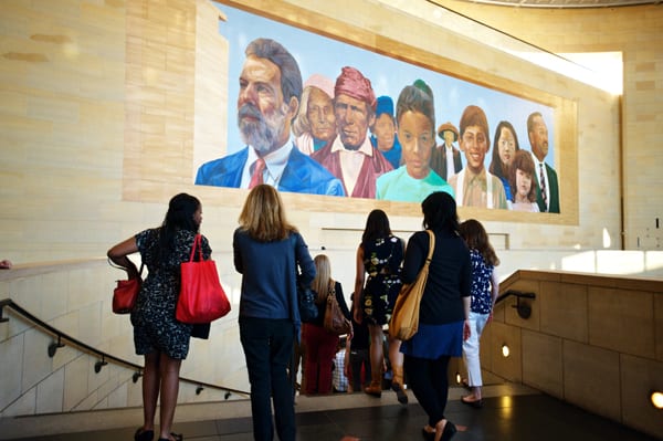 Metro Art tour descending Union Station stairs below the Richard Wyatt mural, City of Dreams, River of History