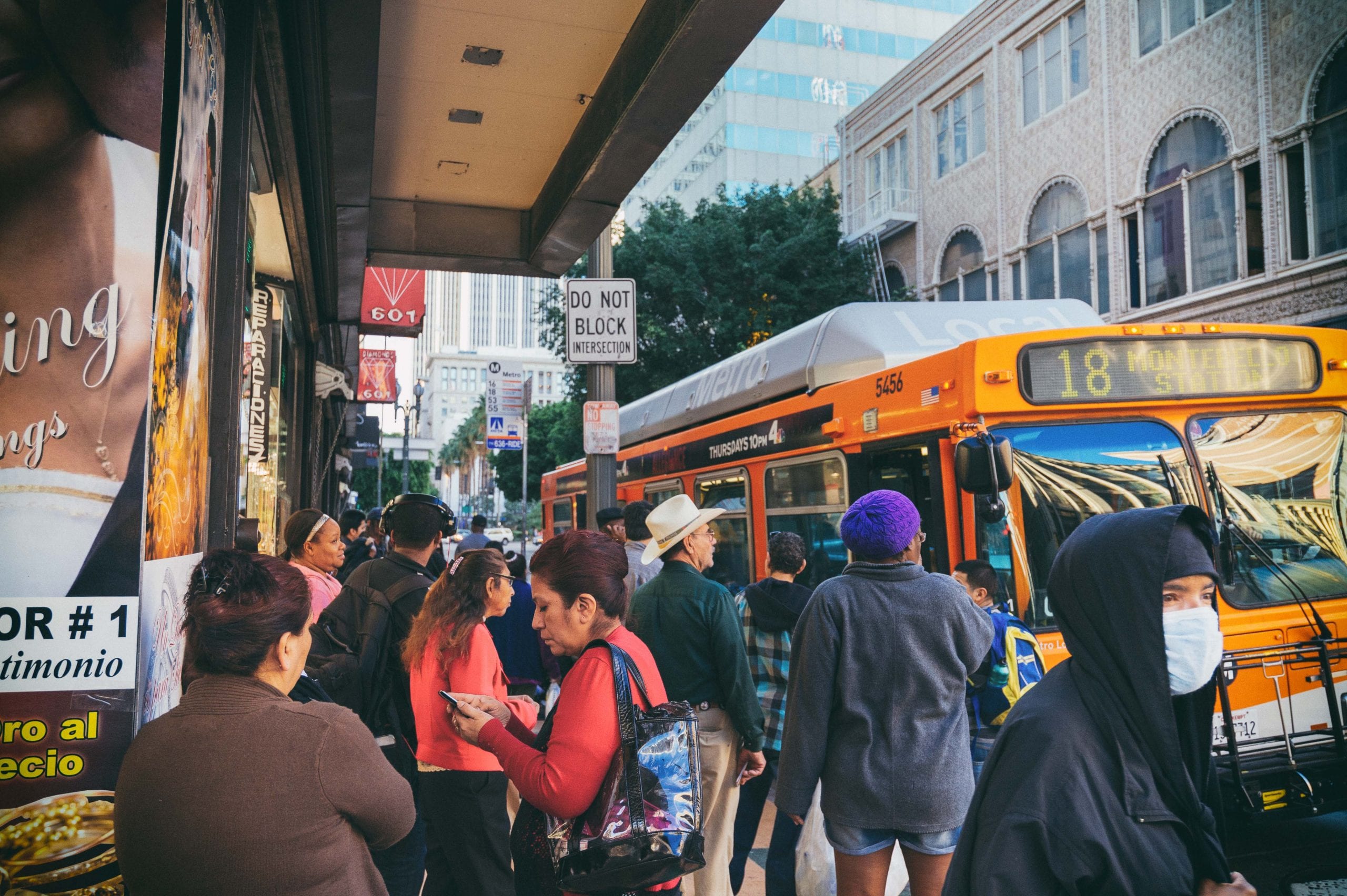 ART OF TRANSIT: The Metro Bus stop at Broadway and 6th in DTLA on Friday. Kind of a cluttered image, but also a good view of the cross-section of riders. Photo by Steve Hymon/Metro.