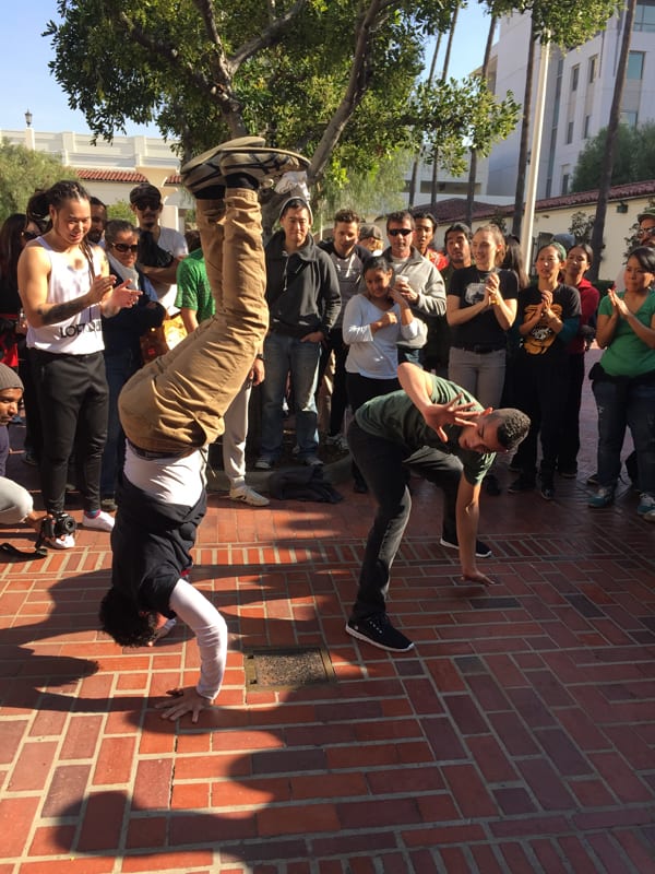 Two capoeiristas play inside a "roda" or circle, comprised of other players, musicians and audience members at Metro Presents: Capoeira Exchange on Jan. 3 at Union Station