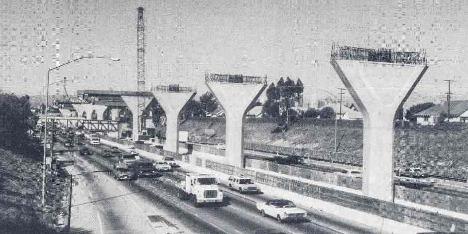 Construction of the elevated portion of the Harbor Transitway on the 110 freeway south of DTLA. Photo: Metro Library.