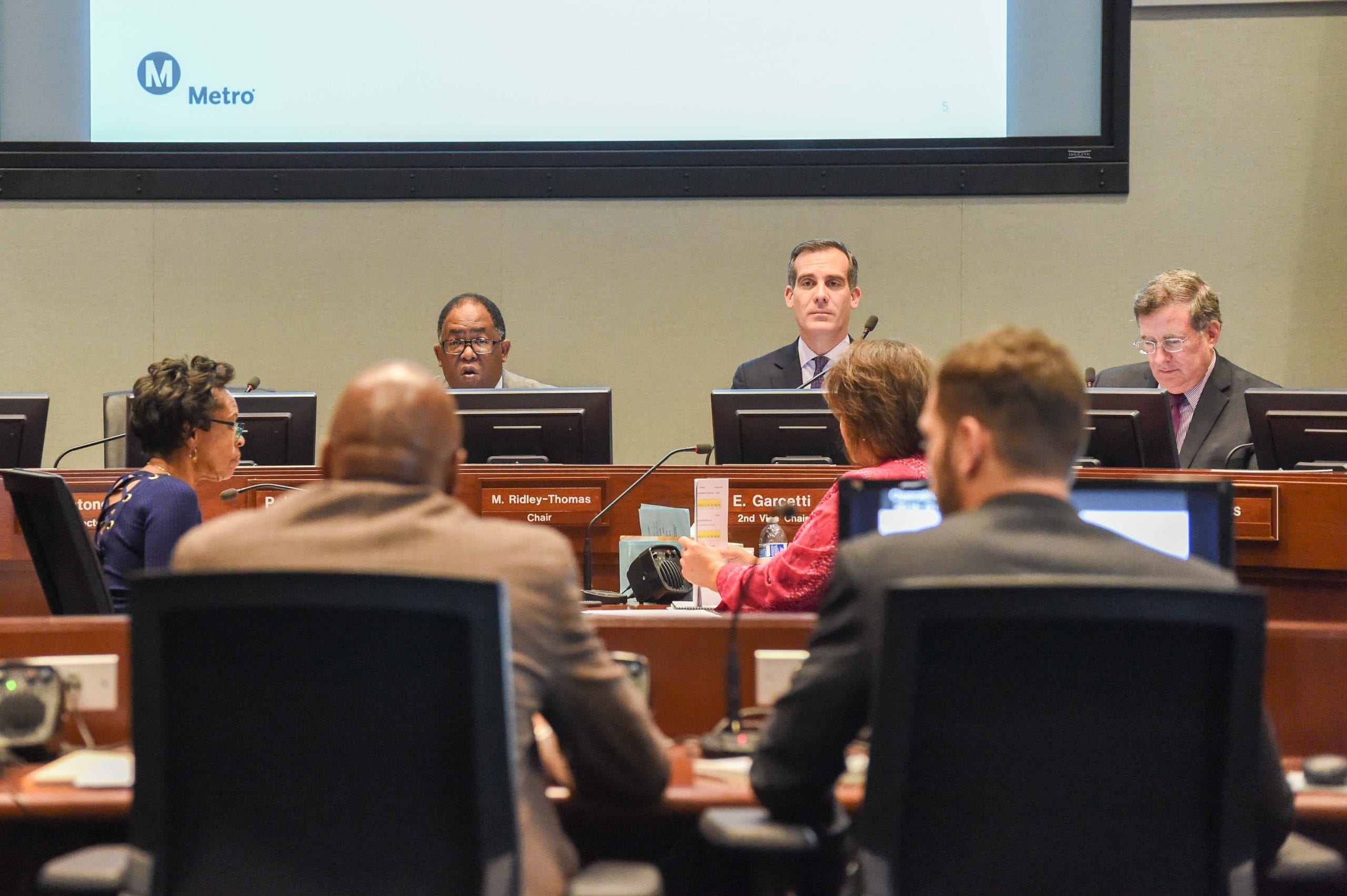 Metro Board Chair and Supervisor Mark Ridley-Thomas, left, and Board Member and L.A. Mayor Eric Garcetti listen to Washington's remarks on Thursday. 