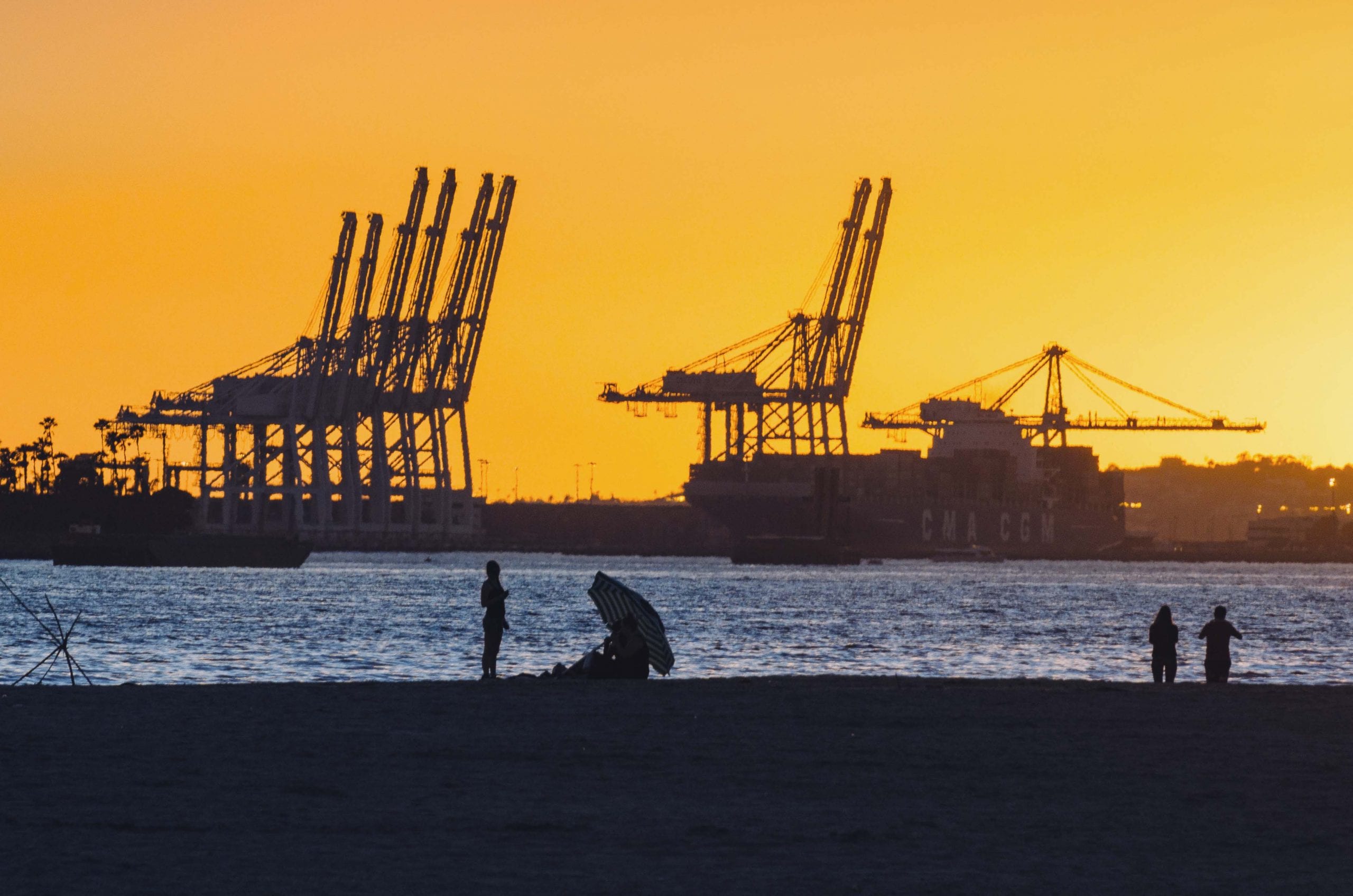 We don't post enough photos about goods movement. Sunset + beach + Port of Long Beach. Photo by Steve Hymon.