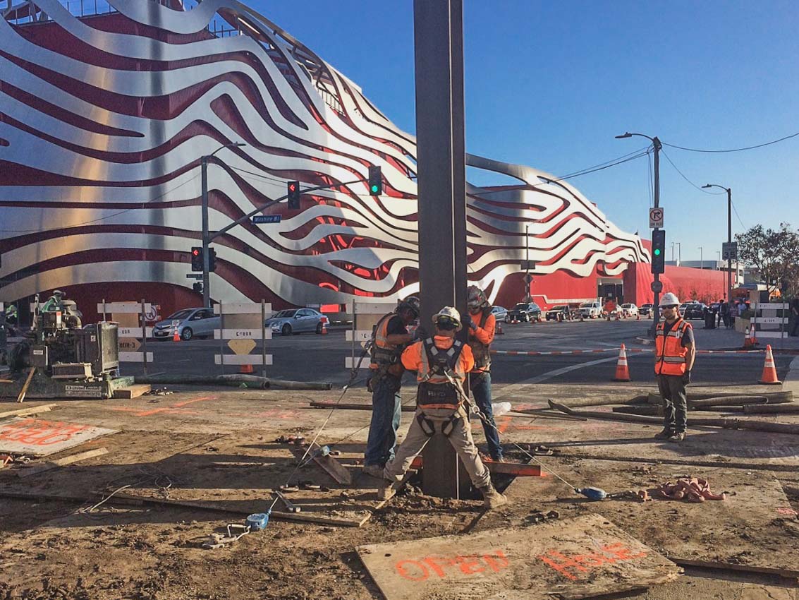 C1045-161002-530pm Condon Johnson setting Pile #168 North in drilled hole on Wilshire Blvd at Fairfax Ave facing south