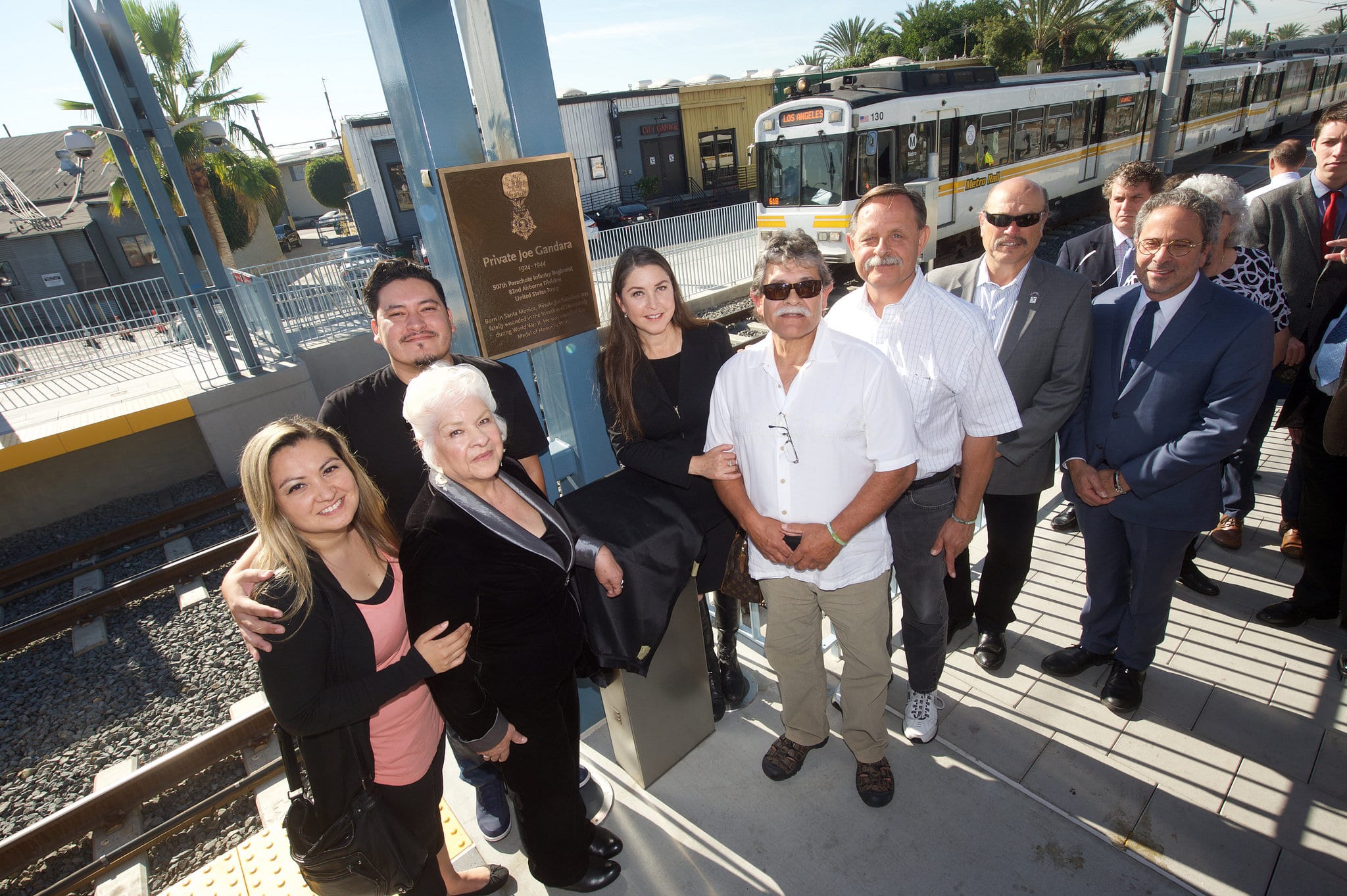 Members of Joe Gandara's family and Santa Monica officials at 26th St/Bergamot Station on Friday. Photo by Gary Leonard for Metro.