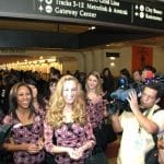 2012 Rose Queen Drew Helen Washington, left, Princess Morgan Eliza Devaud and Princess Kimberly Victoria Ostiller greet transit patrons at Union Station.