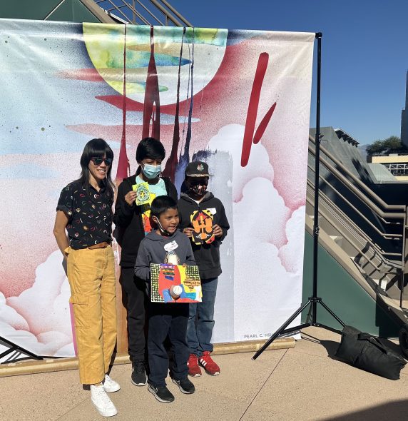 Artist Pearl C. Hsiung takes a photo with a few HOLA students.