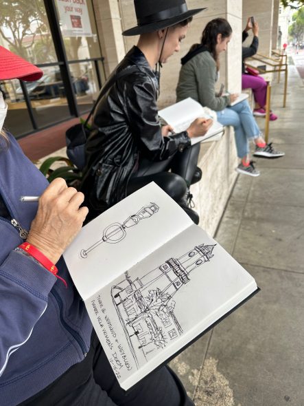 Participants sketching the 1929 Holmbry Hall, a notable landmark in the Westwood neighborhood.
