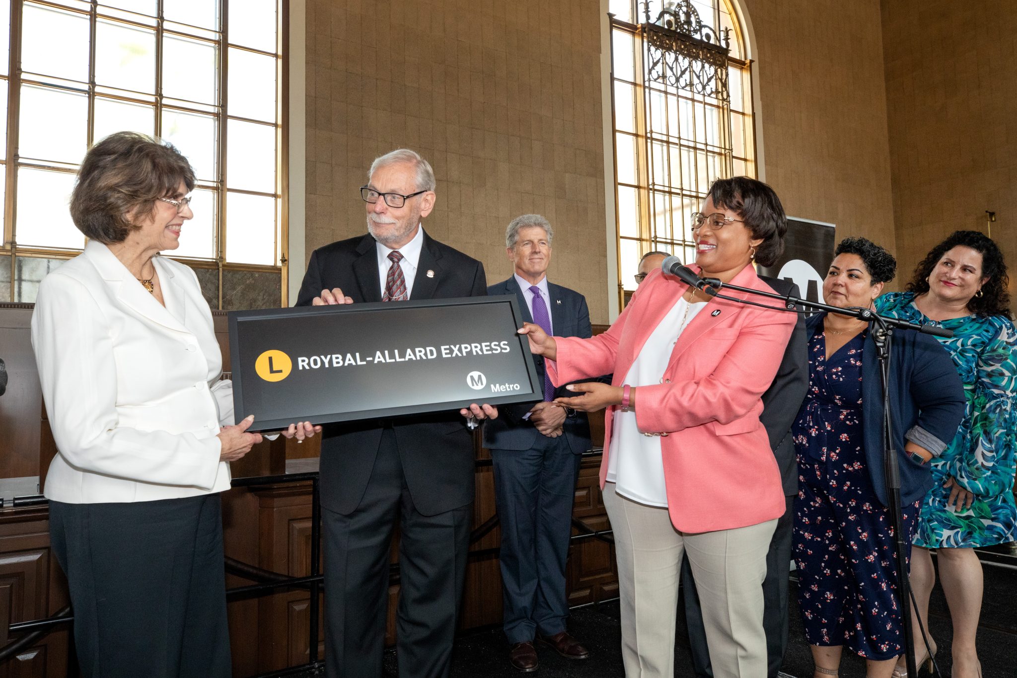 From left: Rep. Lucille Roybal-Allard, former Metro CEO Roger Snoble and Metro CEO Stephanie Wiggins hold a sign saying "L Line: Roybal-Allard Express"